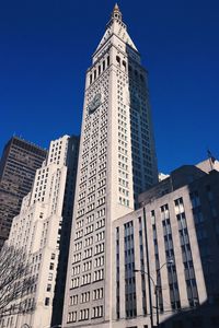 Low angle view of buildings against clear blue sky