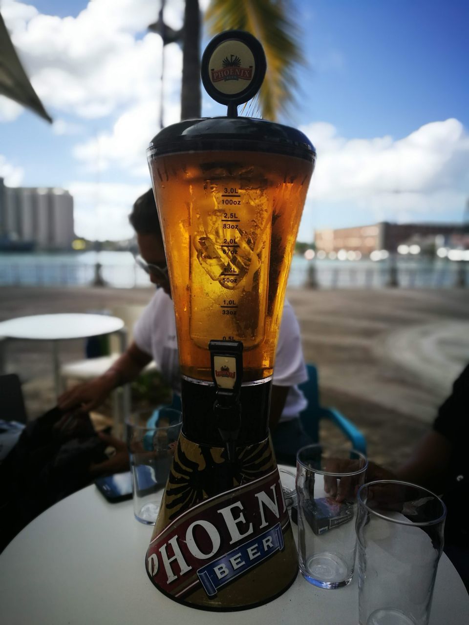 CLOSE-UP OF GLASS OF BEER AGAINST SKY