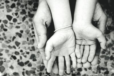 Cropped image of father and child hand at home