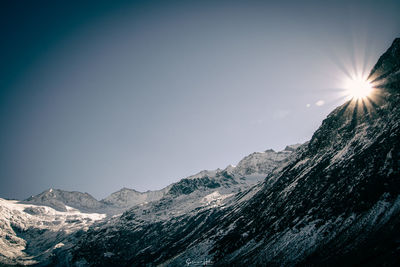 Scenic view of snowcapped mountains against clear sky