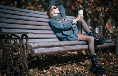 Woman sitting on bench in park