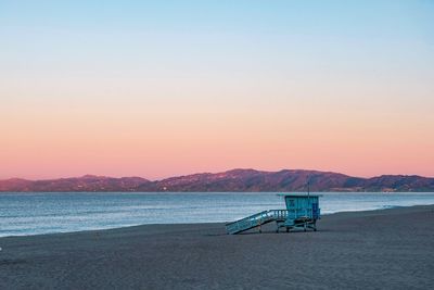 Scenic view of beach against sky during sunset