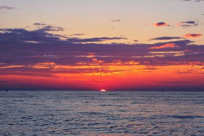 Scenic view of sea against romantic sky at sunset