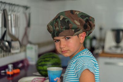 Portrait of boy wearing cap at home