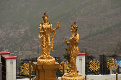 Statue of a building with city in background