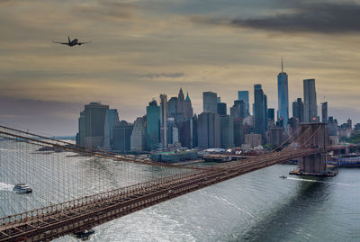 Aerial view of buildings against cloudy sky