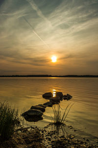 Scenic view of lake against sky during sunset
