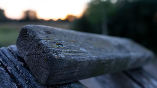 Close-up of old wood against sky during sunset