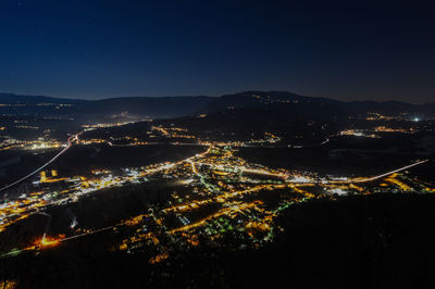 High angle view of illuminated cityscape against sky at night