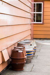 Stack of potted plant by window of building