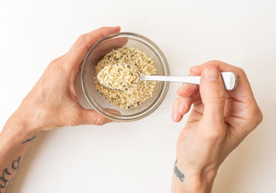 Directly above shot of woman holding bowl against white background