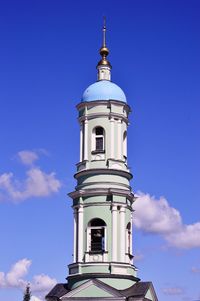 Low angle view of bell tower against blue sky