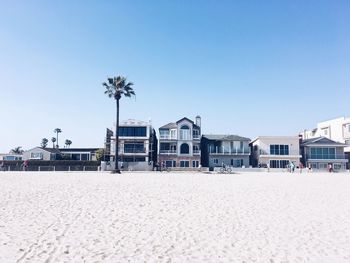 Built structure on beach against clear sky