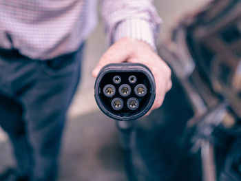 Close-up of human hand holding camera