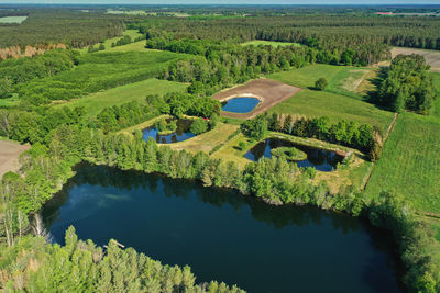 Aerial view of a large rectangular pond in front of smaller ponds in a flat landscape