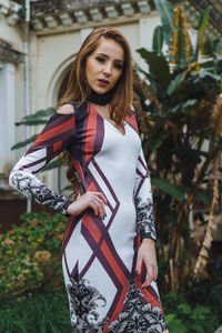 Portrait of young woman standing outdoors