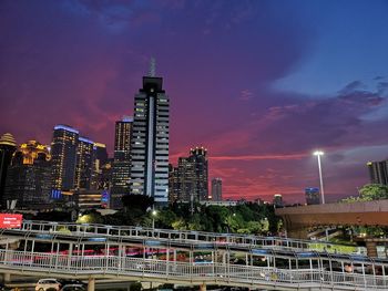 Modern buildings in city against sky at night