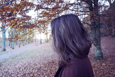 Close-up of woman standing against trees