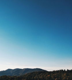 Scenic view of mountains against clear blue sky