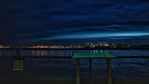 Illuminated cityscape against sky at night