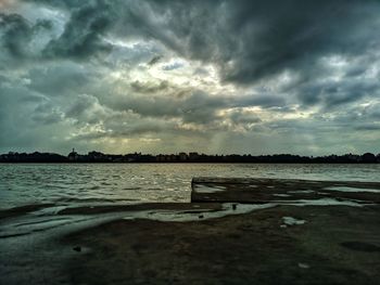 Scenic view of beach against sky during sunset