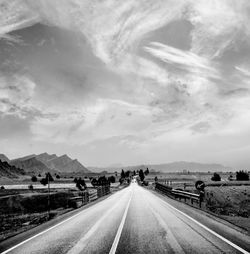 View of highway against cloudy sky