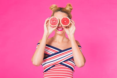 Rear view of woman with hat against yellow background