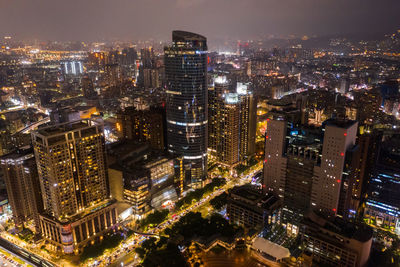 High angle view of illuminated buildings in city at night