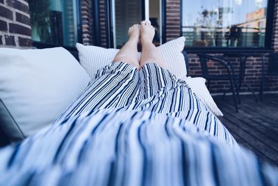 Midsection of woman with umbrella in city