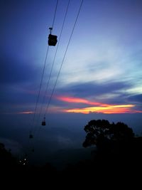 Low angle view of overhead cable car against sky