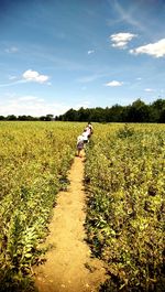 Person standing on field against sky