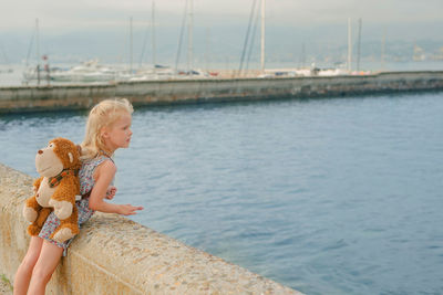 Little girl looking at sea