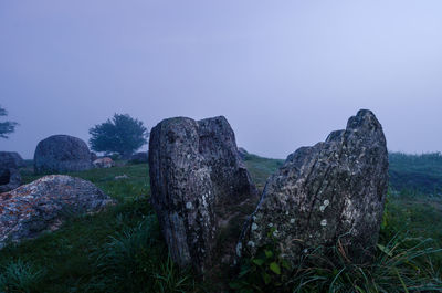 Rocks on land against clear sky