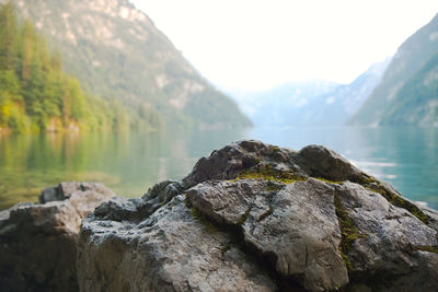 Scenic view of rocks in lake against mountains