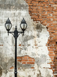 Close-up of street light against wall