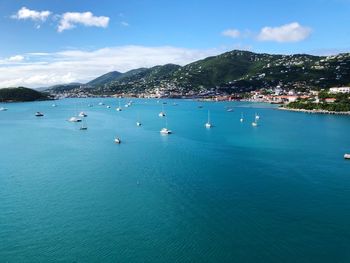 Scenic view of boats in sea against sky