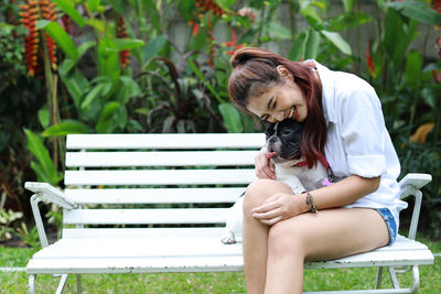 Man with dog sitting on bench