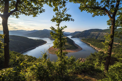 Scenic view of lake and mountains against sky