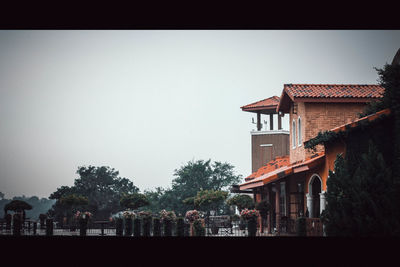People on roof against clear sky