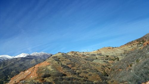 Scenic view of mountains against clear blue sky