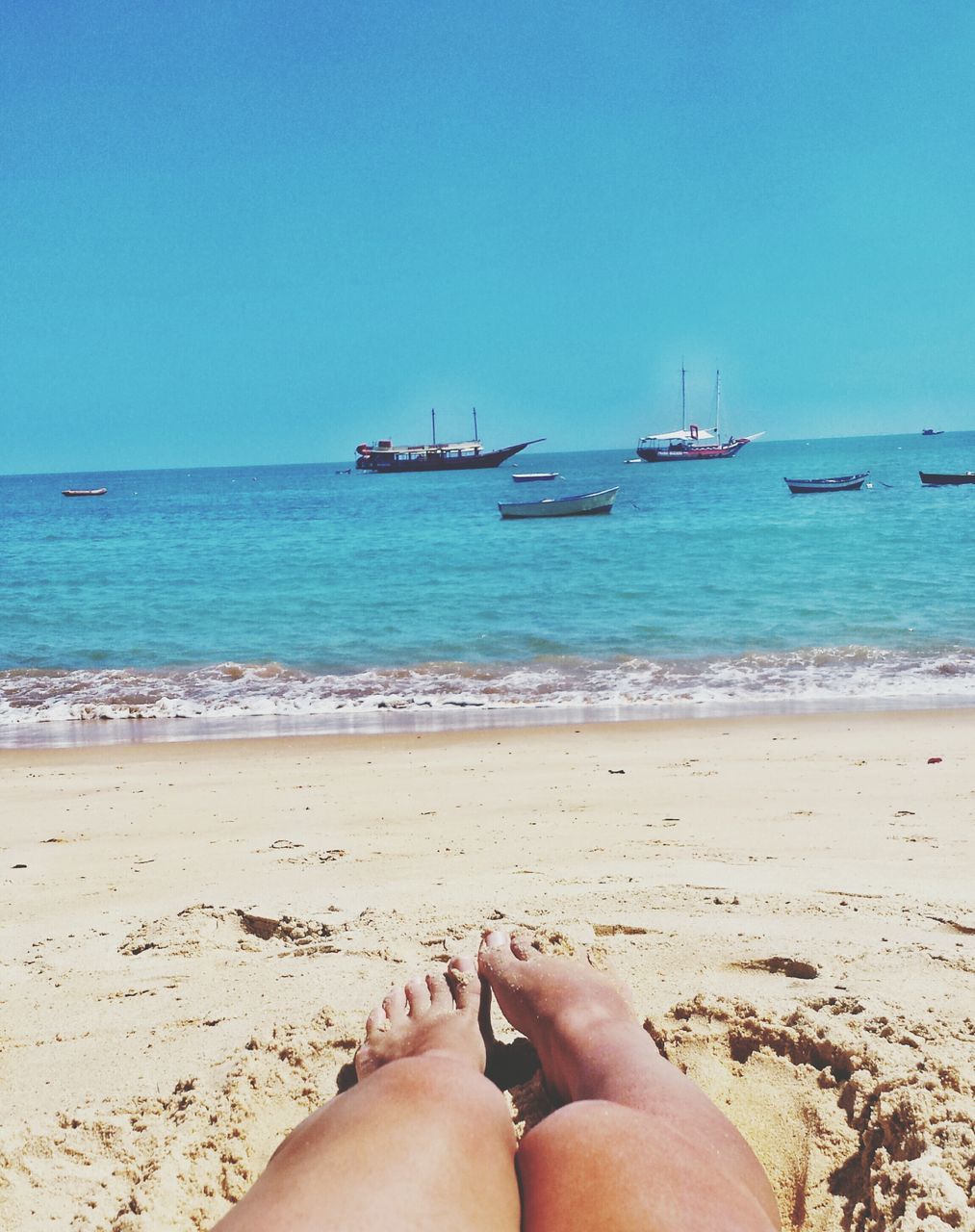 sea, beach, horizon over water, water, sand, shore, clear sky, vacations, personal perspective, tranquility, relaxation, leisure activity, person, scenics, lifestyles, tranquil scene, barefoot