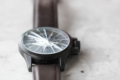 Close-up of broken wristwatch on table
