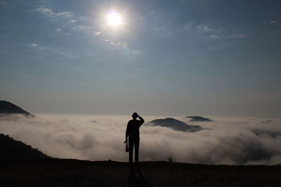 Silhouette of man against sky at night