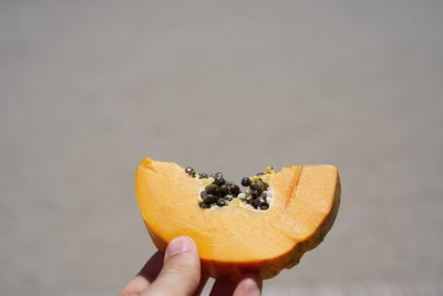 Midsection of person holding fruit