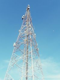 Low angle view of communications tower against blue sky