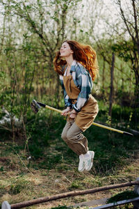 Full length of young woman standing on field