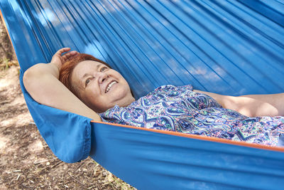 High angle view of woman lying on bed