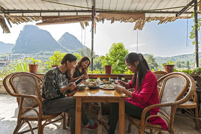 Three female friends having lunch on terrace