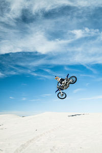 Person riding motorcycle on sand