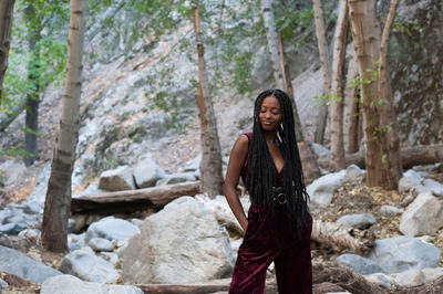 Young woman standing on rock